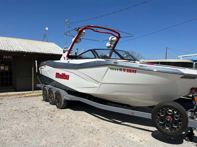 Malibu wake boat on a trailer outside the shop
