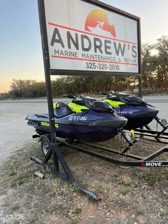 Andrew's Marine Maintenance & Repair roadside sign with two Sea-Doo personal watercraft on trailers